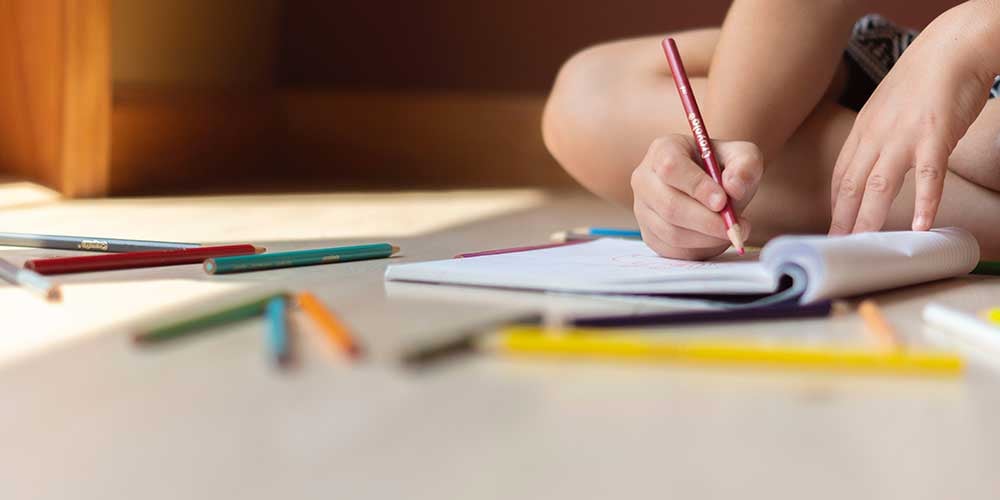 child writing on some paper