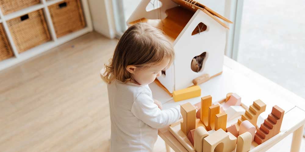 girl playing with montessori toy