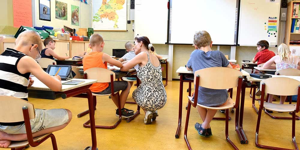 children sitting in a classroom