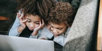 Two children using a computer with good technology habits