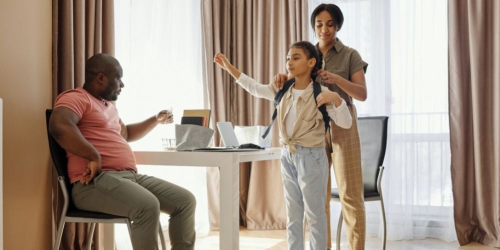 girl getting ready for school with parents