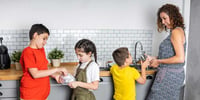 mother and children doing dishes together