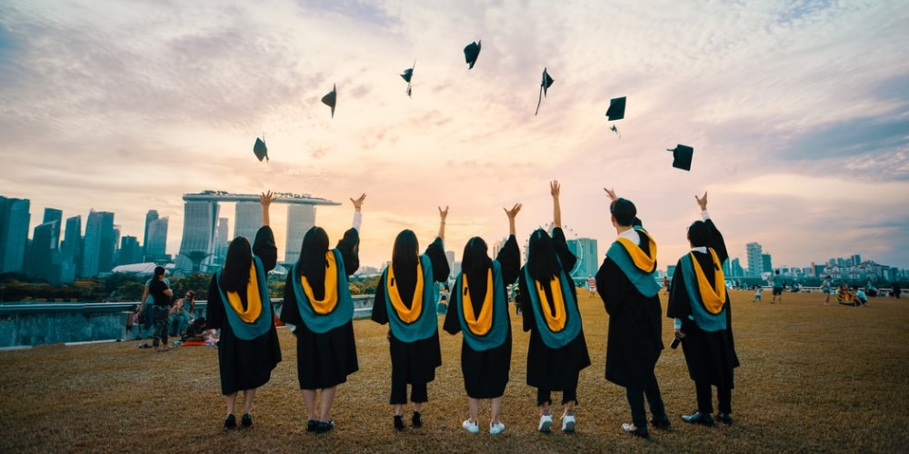 students throwing up their caps at graduation