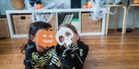 two children in halloween costumes