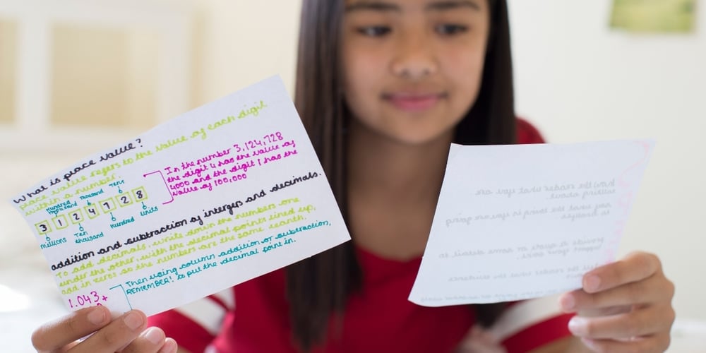 girl using revision cards to study