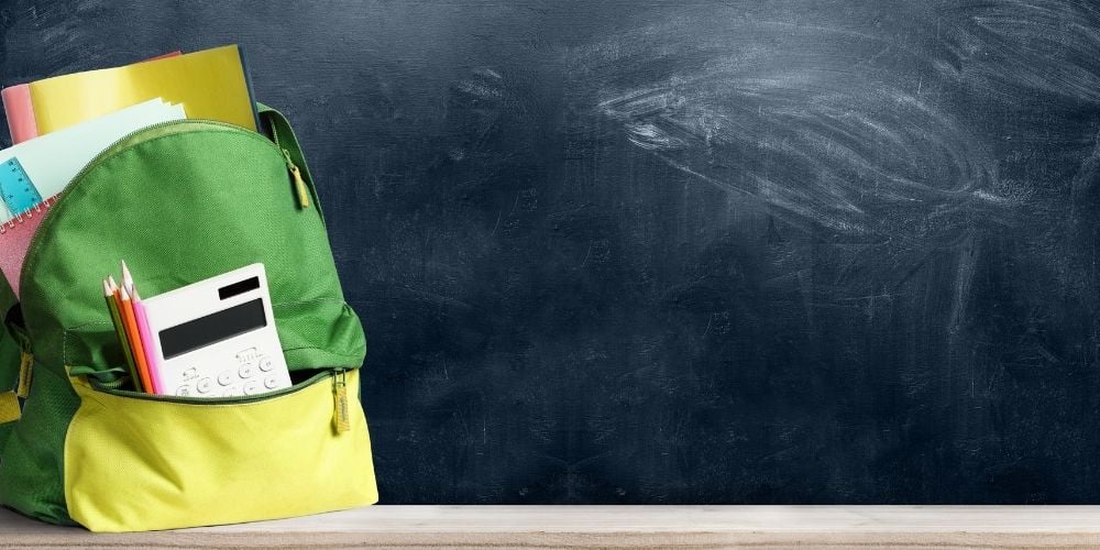 school backpack in front of chalkboard