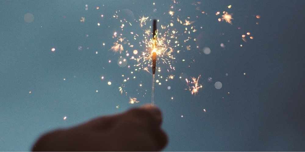 hand holding sparkler on bonfire night