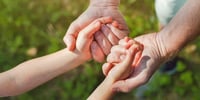 parent holding hands with child