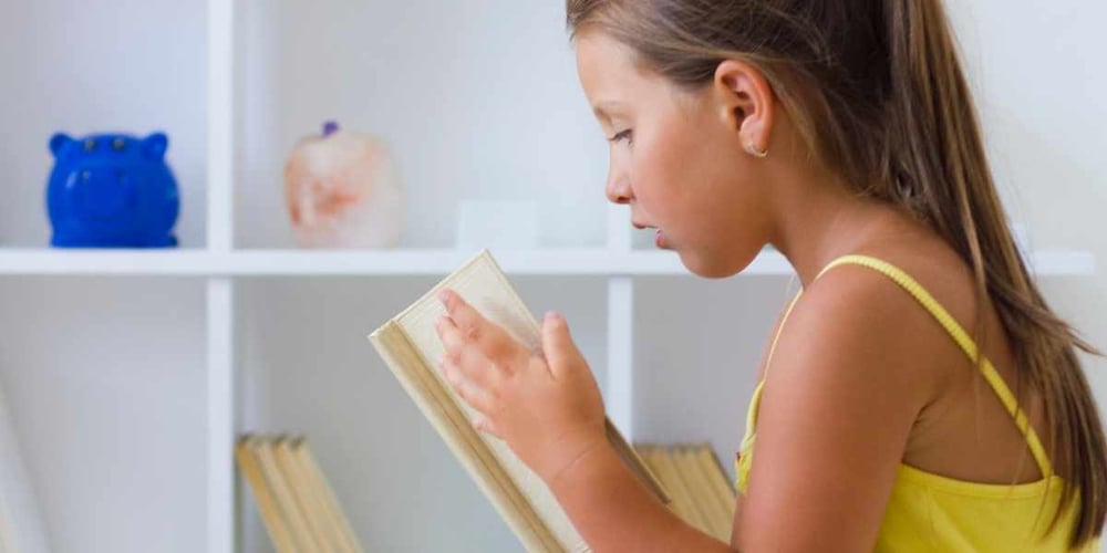 girl reading confidence building book