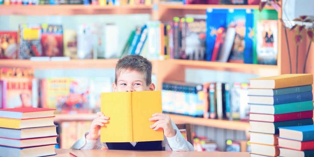 kid reading in library