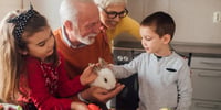 children stroking an animal with grandparents
