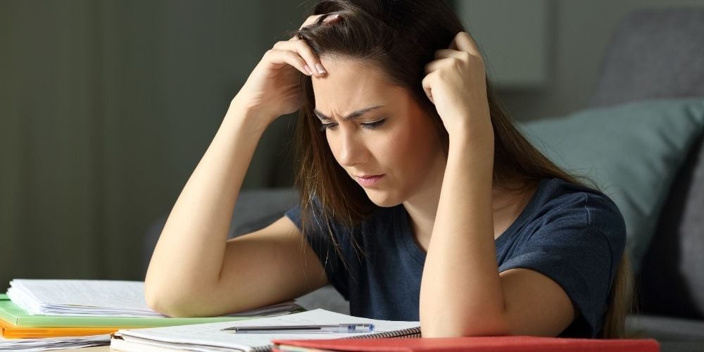 girl studying for GCSEs at desk