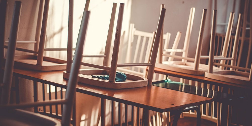 school classroom with chairs on the tables