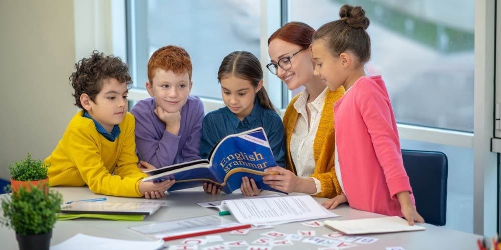 children studying 11 plus books with a teacher