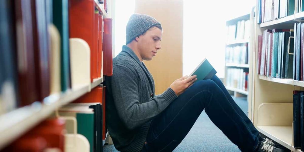 teen studying in library