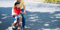 parenting teaching child to ride a bike