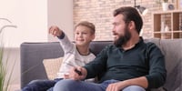 father and son sitting on the couch