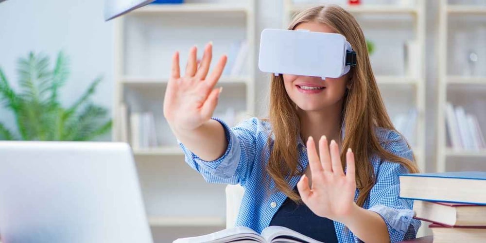 girl trying virtual reality at desk
