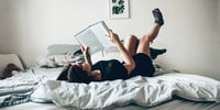 Girl reading best books for teens in bed