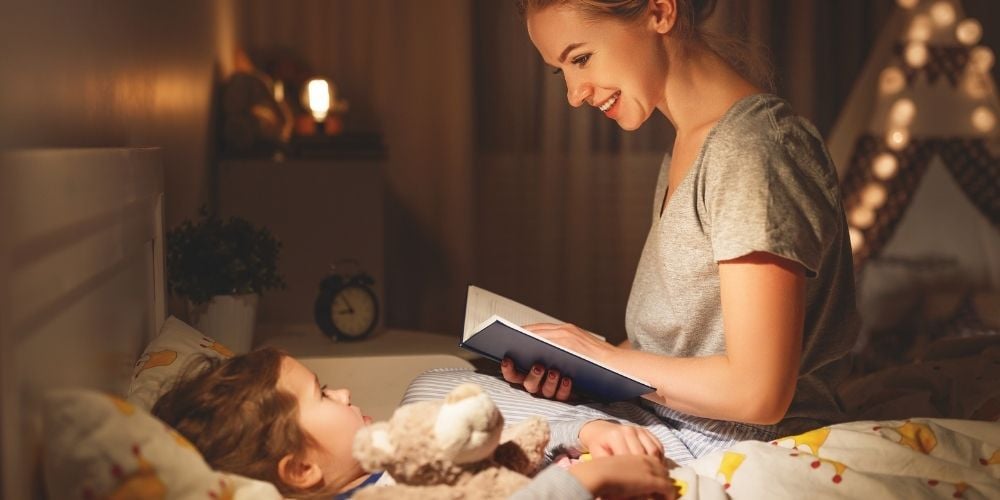 parent reading bedtime story to child