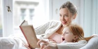 mum and child reading book together