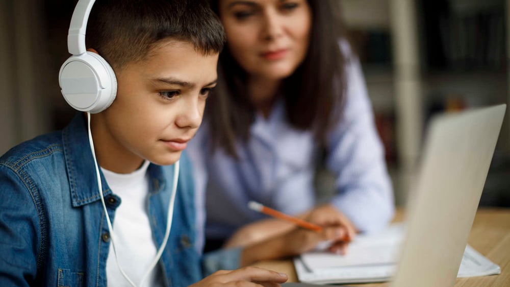 mum and son doing online tutoring