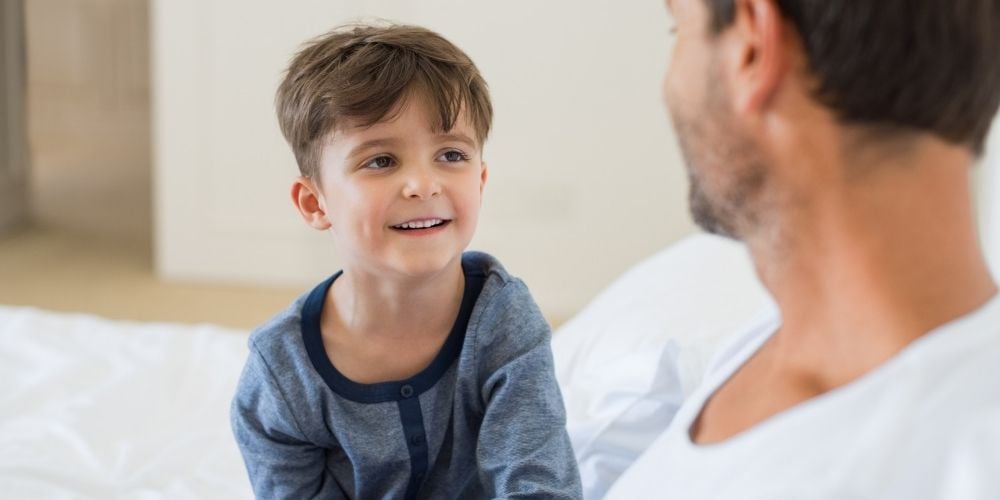 young boy talking with father