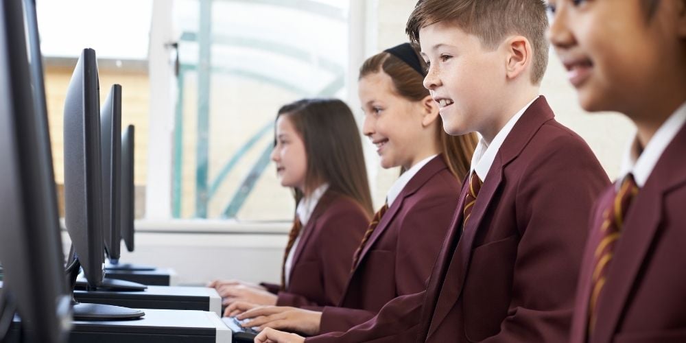 kids in uniform on computers