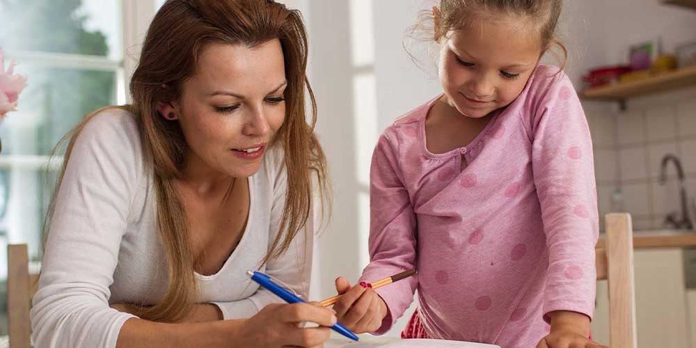 mother with child writing at a desk