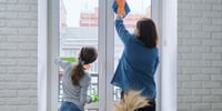mum and child cleaning windows