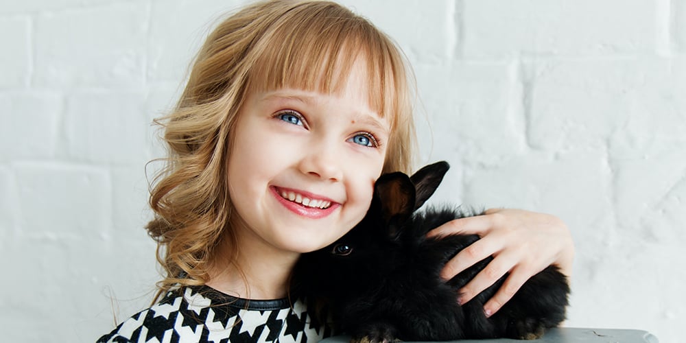 little girl with pet rabbit