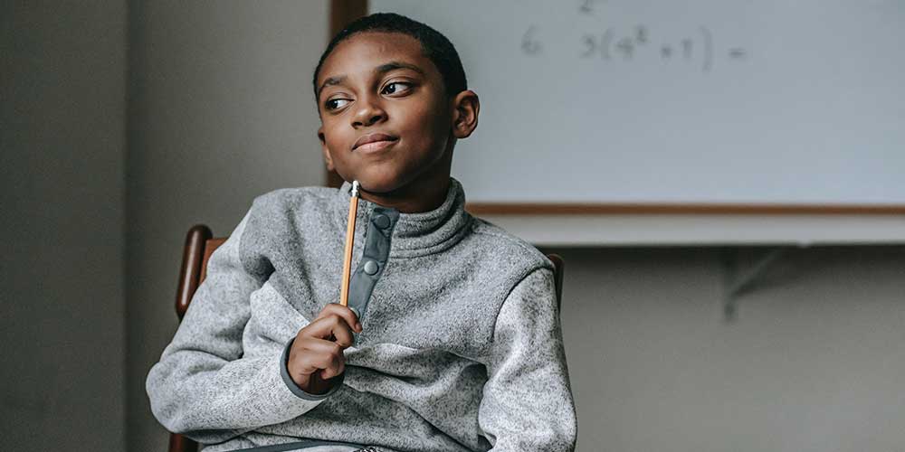 boy with pencil thinking about exam tips