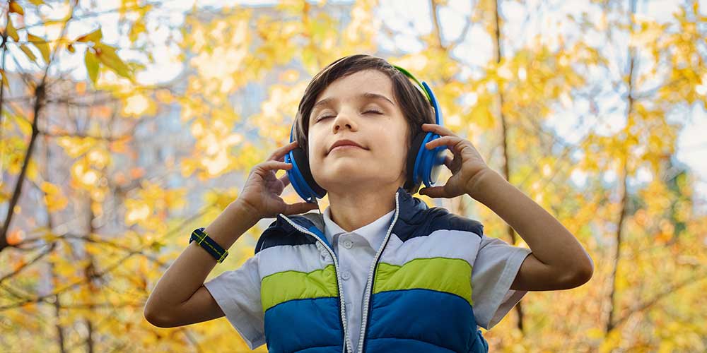 boy listening to music on headphones