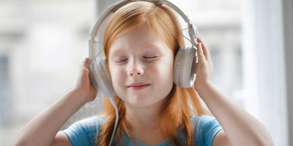 girl listening to podcast on headphones