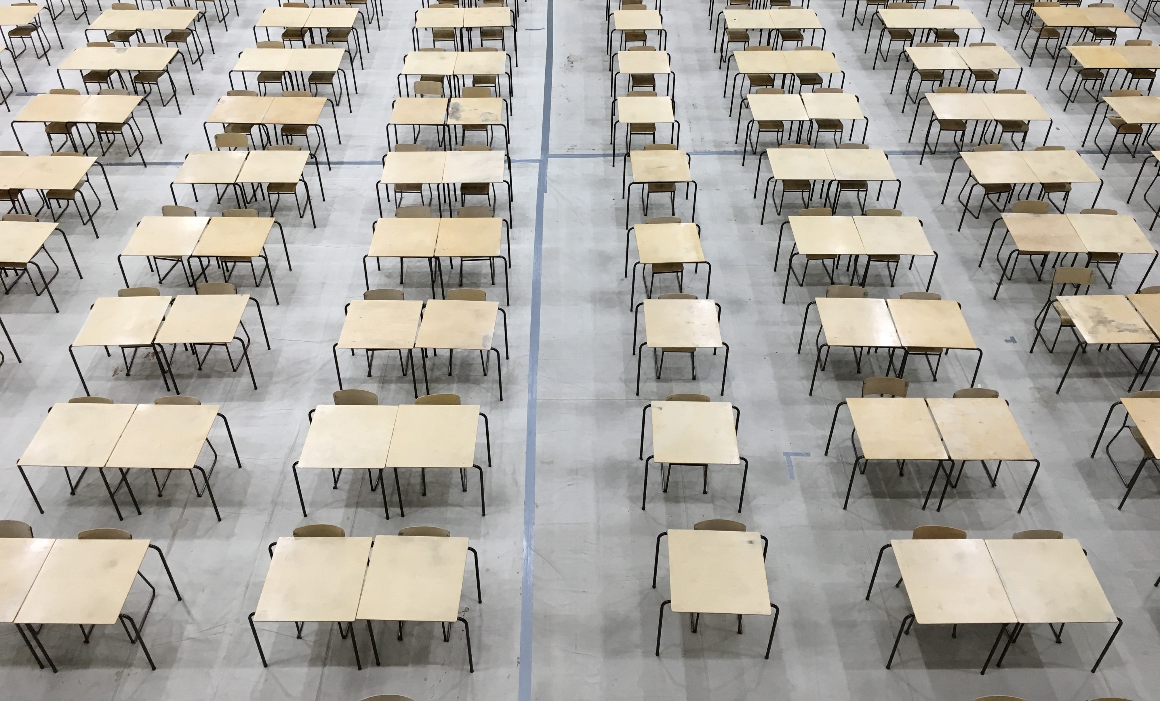 exam hall with lots of tables and chairs