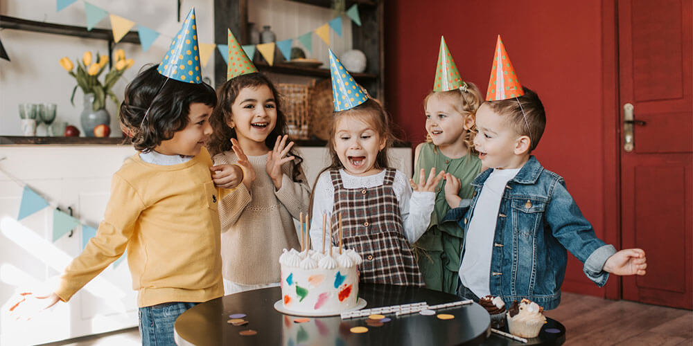 children at a party with a cake
