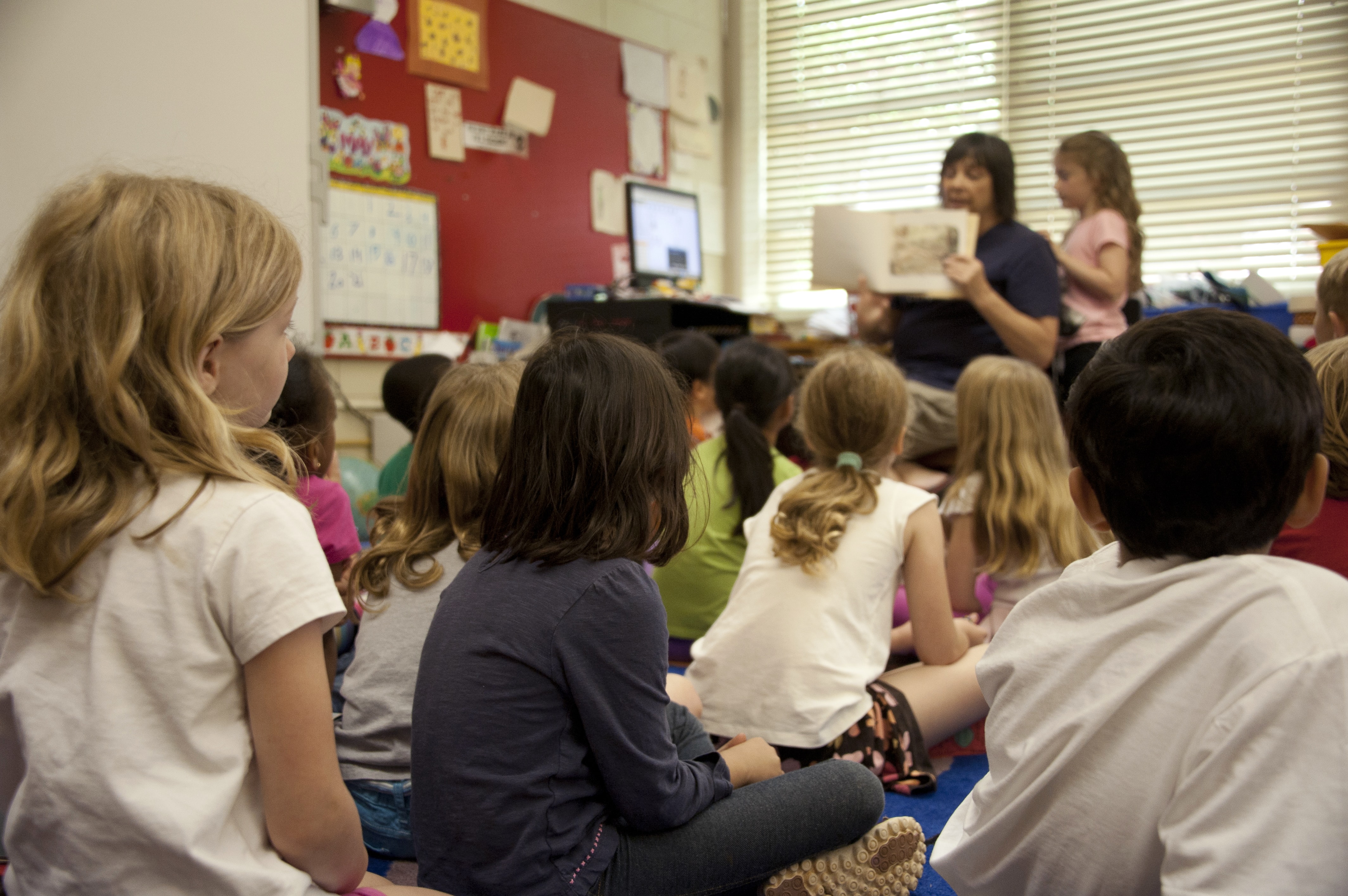 children sitting down in a classroom