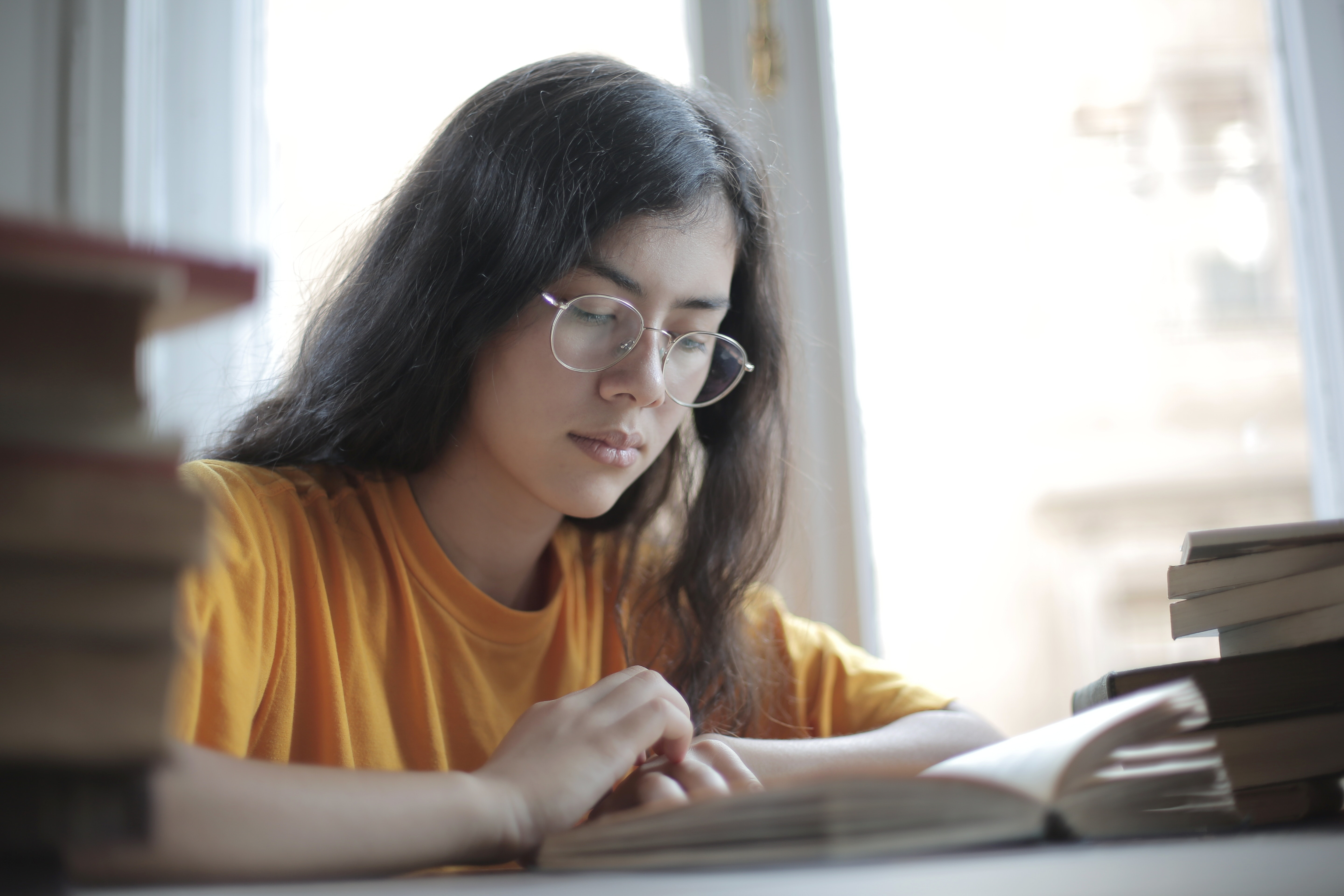 girl with glasses studying