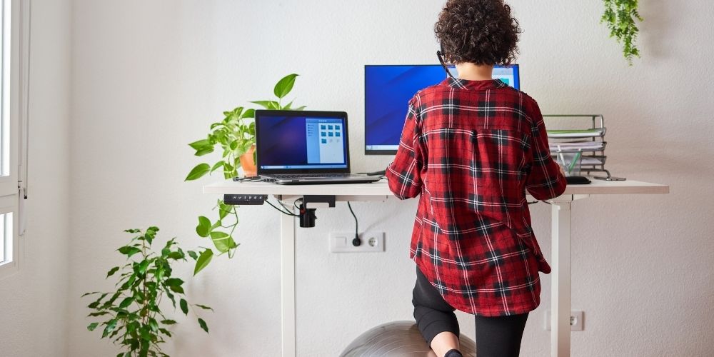 woman working on standing desk